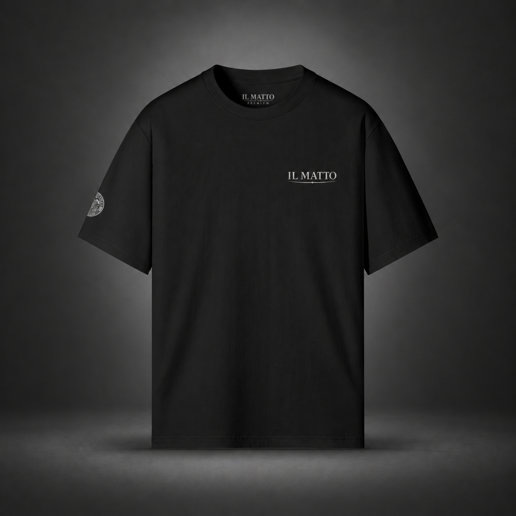 IL MATTO Premium Emblem Tee — black front on charcoal studio background