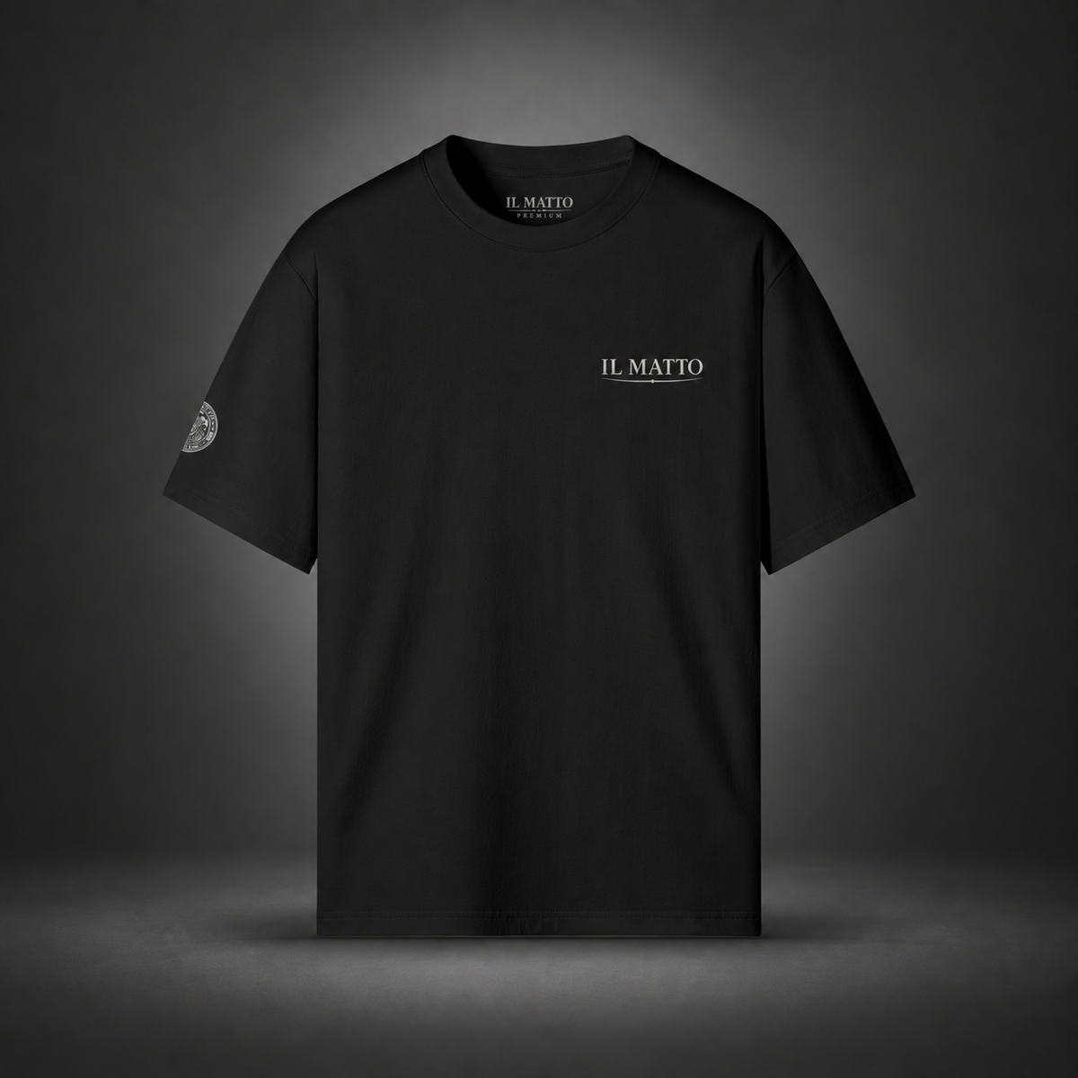 IL MATTO Premium Emblem Tee — black front on charcoal studio background