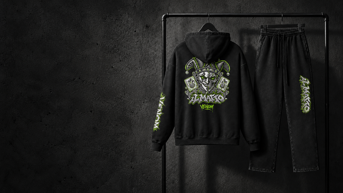 IL MATTO VENOM faded-black Signature hoodie and matching sweatpants hanging against charcoal concrete